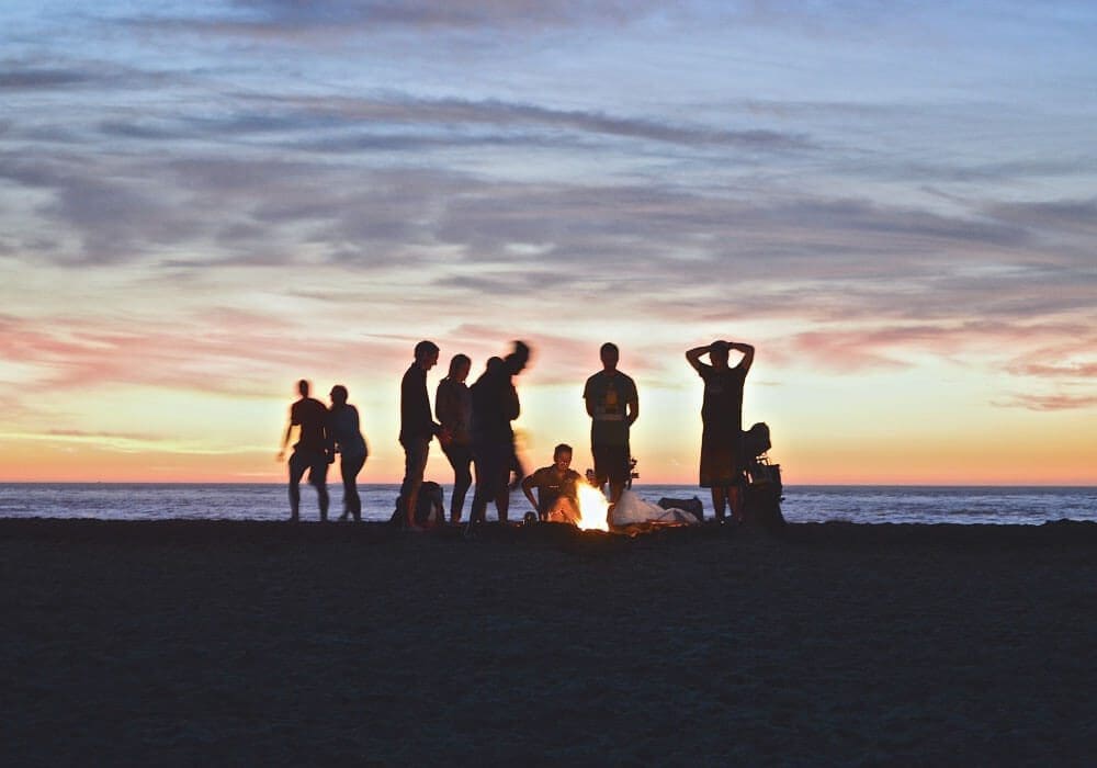 caribbean-feature-8 people enjoying a bon fire on the beach